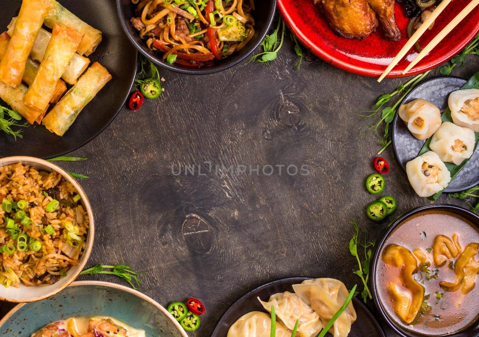 Chinese food dark background. Chinese noodles, fried rice, dumplings, peking duck, dim sum, spring rolls. Famous Chinese cuisine dishes set. Space for text. Top view. Chinese restaurant concept