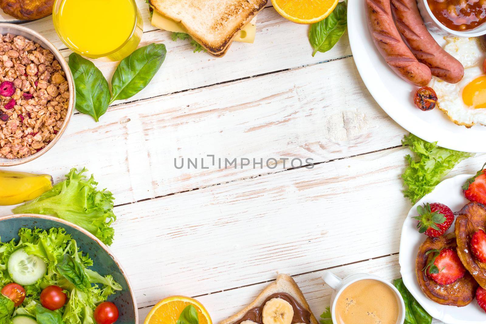 Assortment of breakfast choices. English breakfast, sausages, fried eggs, bacon, salad, granola, cheese sandwich, pancakes, chocolate cream and banana toast, coffee, fresh orange juice. Space for text