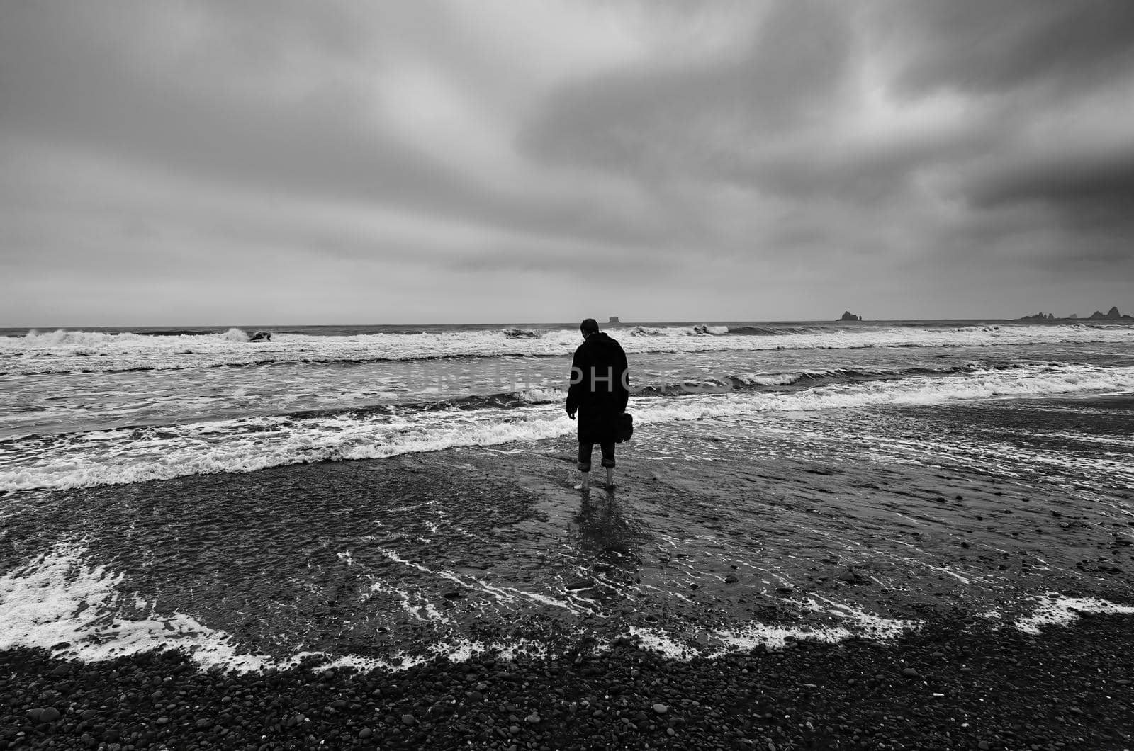 Lonely figure on a stormy beach in Washington