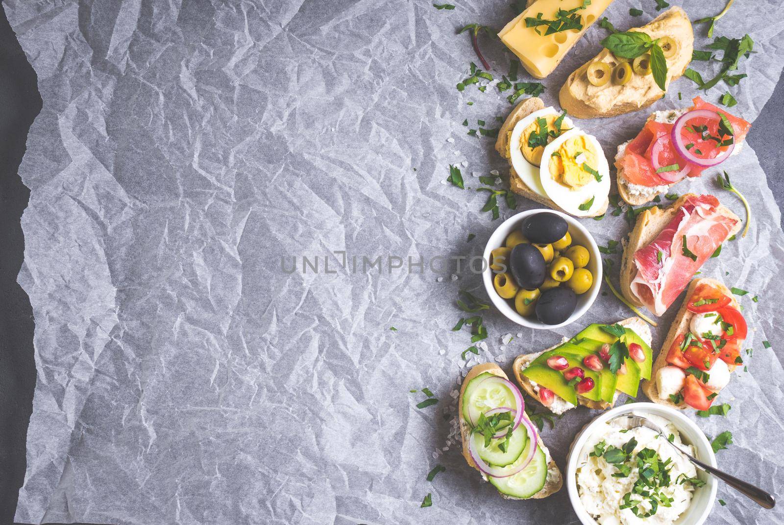 Assorted healthy sandwiches set background. Sandwich bar or buffet. Ciabatta sandwiches with dips, fish, cheese, meat, vegetables, fruits. Space for text. Top view. Ingredients for making sandwiches