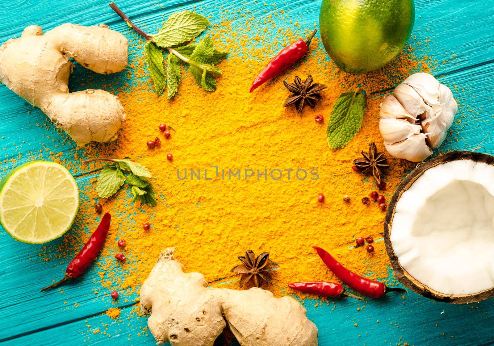 Thai food background. Ingredients for making thai food. Coconut, ginger, hot pepper, lime, curry, herbs, spices. Thai cuisine ingredients on blue wooden background. Space for text. Top view. Close-up