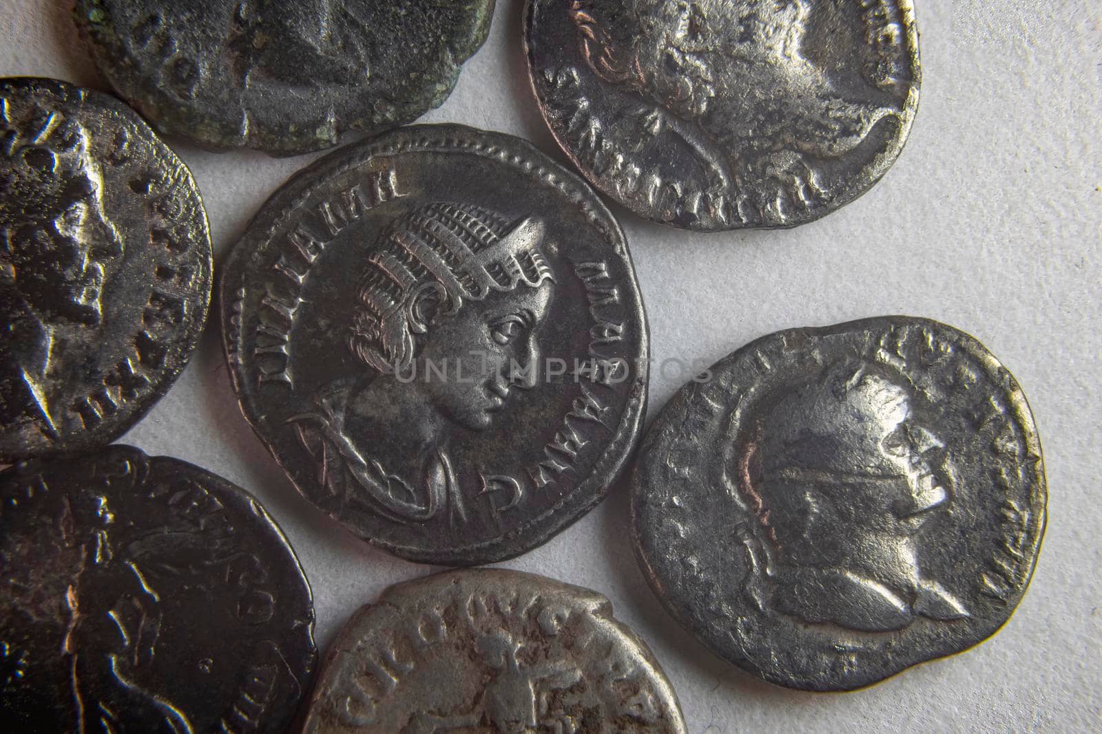 old roman coins on white background close up