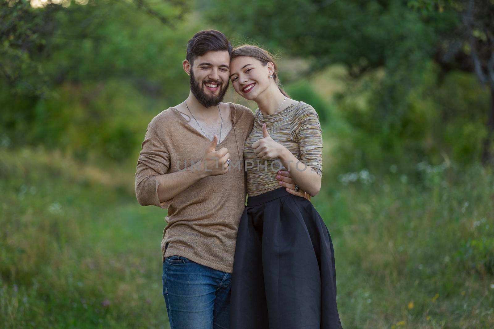 couple shows a gesture that everything is fine being in nature