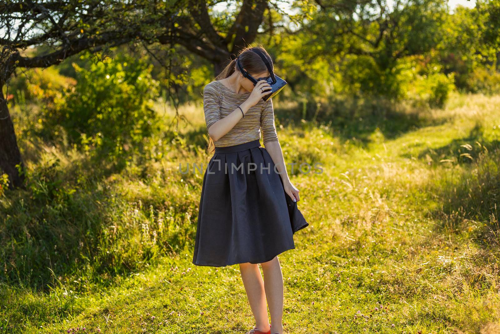 girl with virtual reality gadget in nature