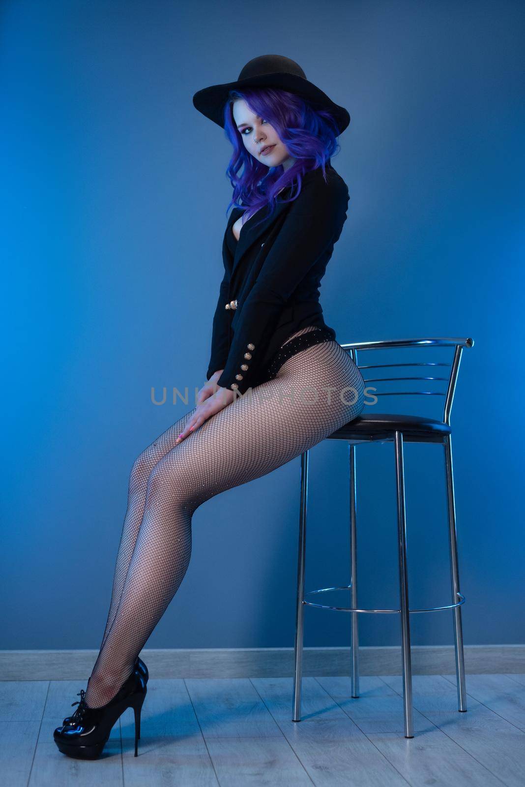 sexy girl in a fashionable jacket and hat poses erotically in her underwear by Rotozey