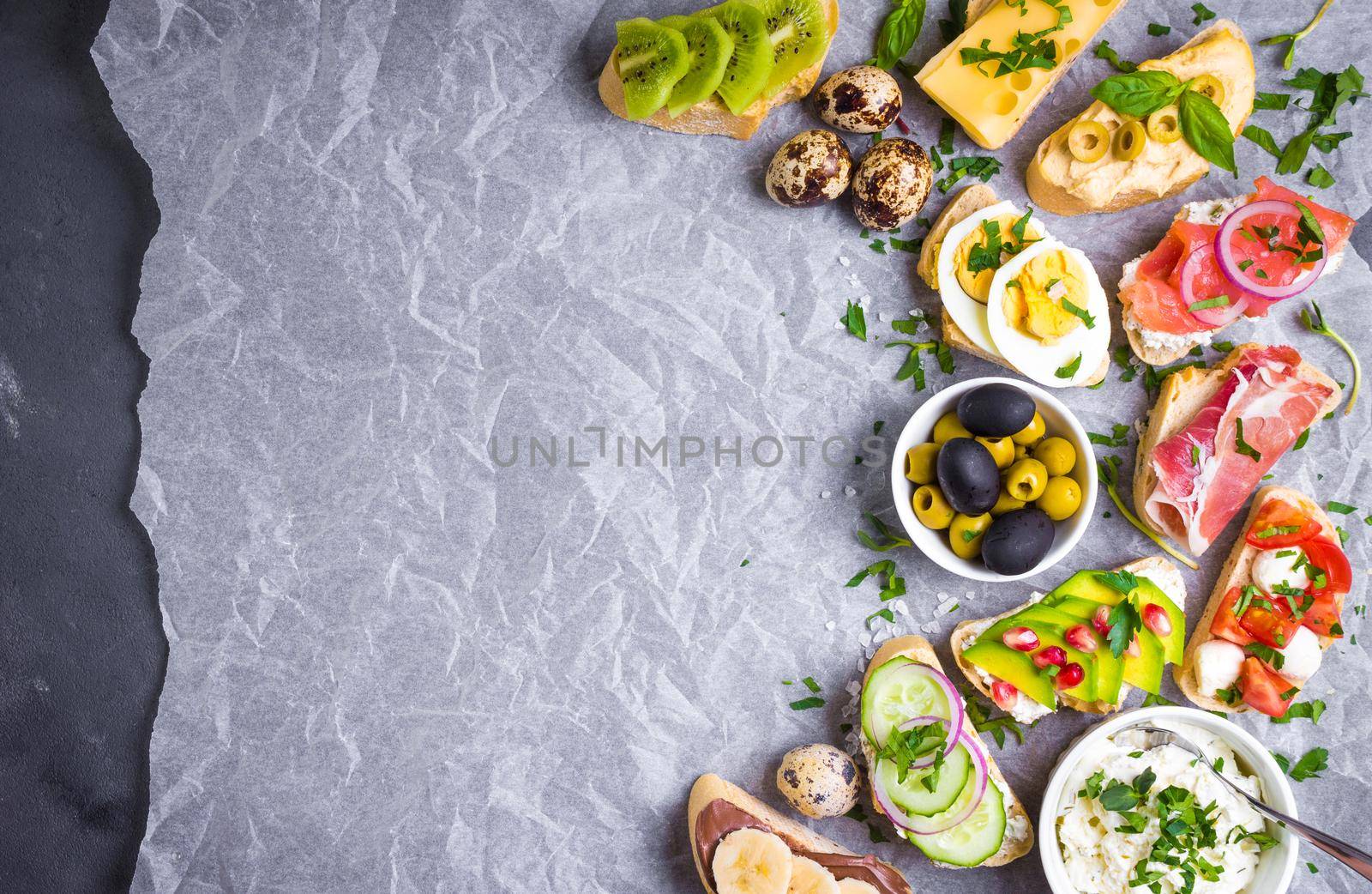 Assorted healthy sandwiches set background. Sandwich bar or buffet. Ciabatta sandwiches with dips, fish, cheese, meat, vegetables, fruits. Space for text. Top view. Ingredients for making sandwiches