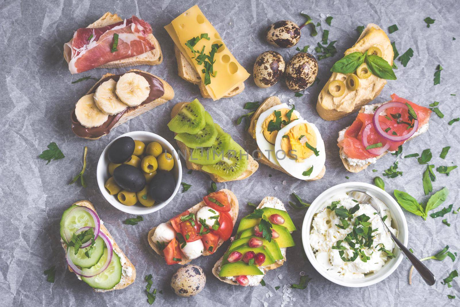 Assorted healthy sandwiches set background. Sandwich bar or buffet. Ciabatta sandwiches with dips, fish, cheese, meat, vegetables, fruits. Top view. Making sandwiches concept. Lunch time snacks