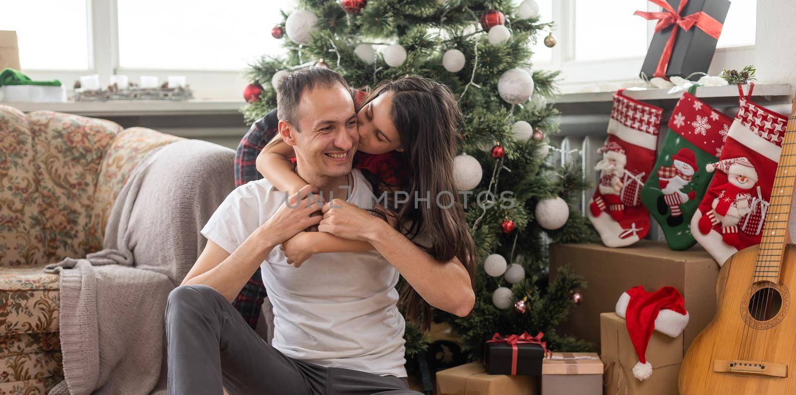 smiling father with daughter celebrating Christmas.