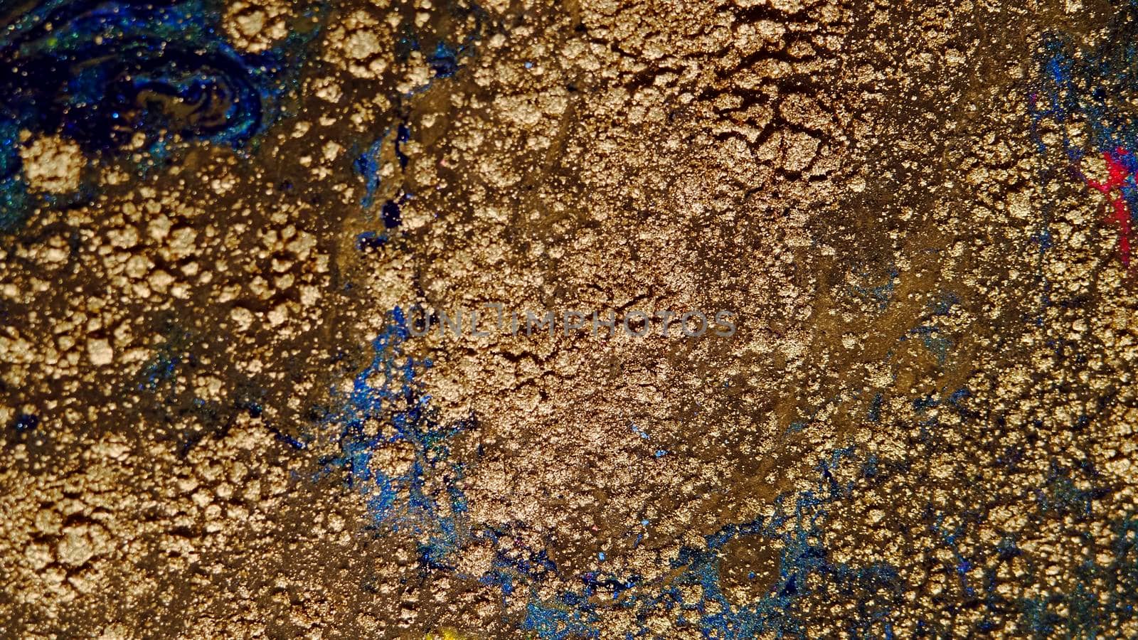 Background of gold dust in a silvery mist with blue, yellow streaks. A unique, natural background created in the technique of the flowing art of resin. Abstractions made of liquid marble. Deep ink blanks.