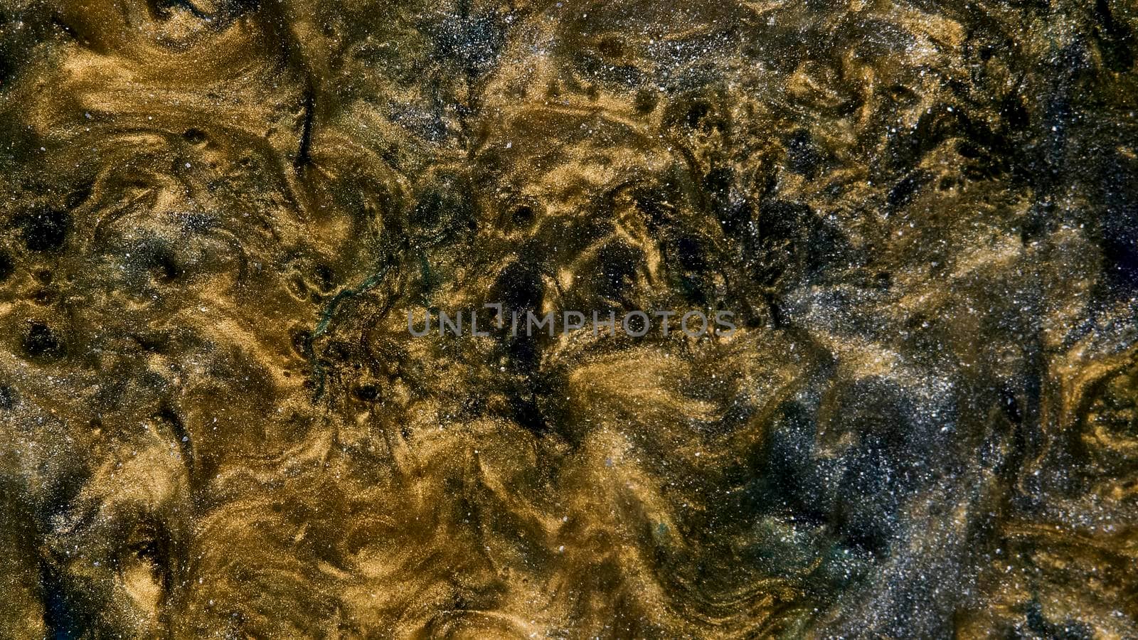 Background of gold dust in a silver mist. A unique, natural background created in the technique of the flowing art of resin. Abstractions made of liquid marble. Deep ink spaces.