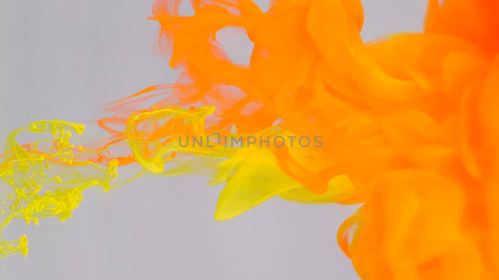 Drops of red and yellow paint dissolved in water. by kenonl