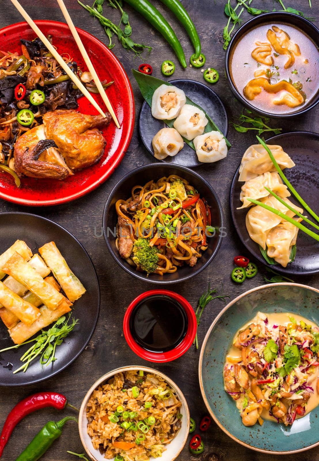 Assorted Chinese food set. Chinese noodles, fried rice, dumplings, peking duck, dim sum, spring rolls. Famous Chinese cuisine dishes on table. Top view. Chinese restaurant concept. Asian style banquet