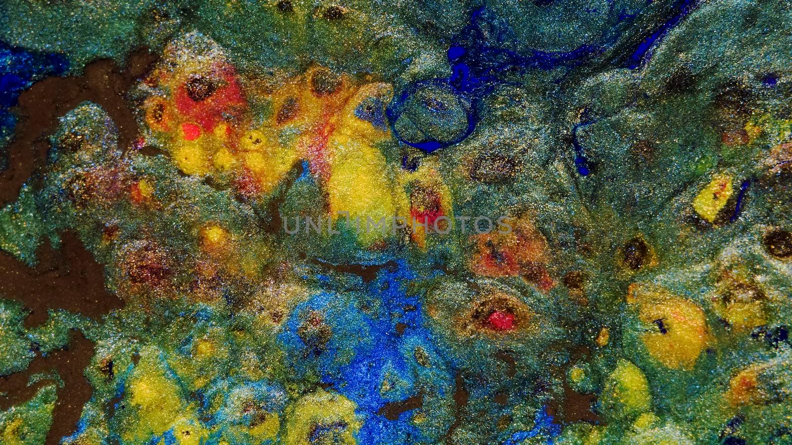 Background of gold dust in a silvery mist with blue, yellow and red streaks. A unique, natural background created in the technique of the flowing art of resin. Abstractions made of liquid marble. Deep ink blanks.
