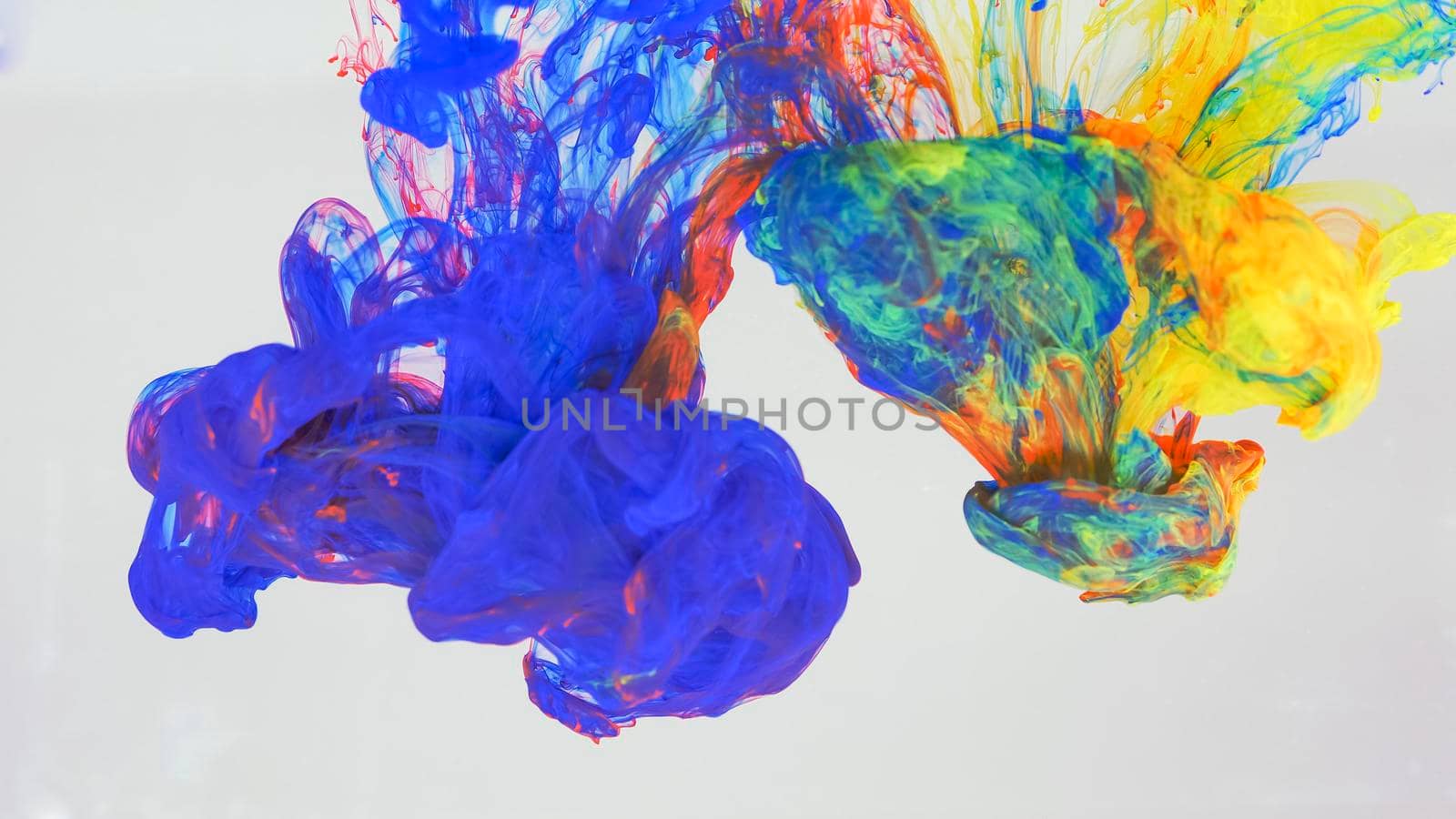 Drops of blue, red and yellow paint dissolved in water. by kenonl