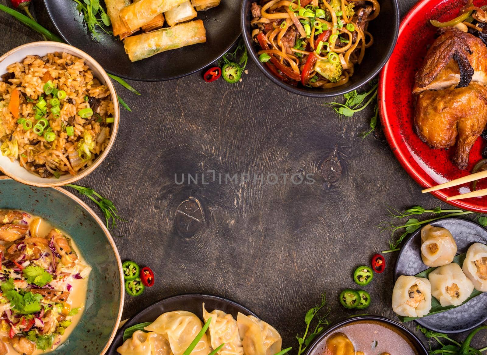 Chinese food dark background. Chinese noodles, fried rice, dumplings, peking duck, dim sum, spring rolls. Famous Chinese cuisine dishes set. Space for text. Top view. Chinese restaurant concept