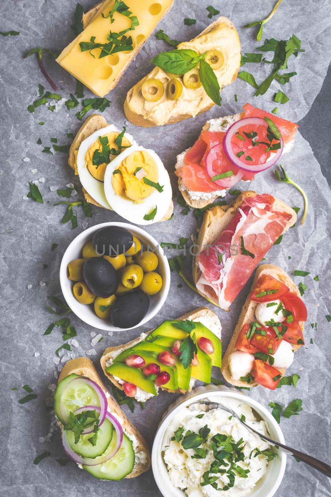 Assorted healthy sandwiches set background. Sandwich bar or buffet. Ciabatta sandwiches with dips, fish, cheese, meat, vegetables. Top view. Making sandwiches concept. Lunch time snacks. From above