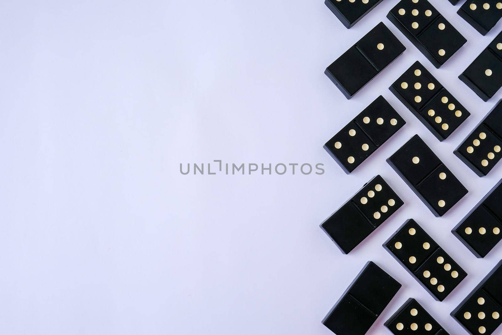 Black old, vintage dominoes on white background. The concept of the game dominoes. Selective focus. Copy space. Pastime. Table games.