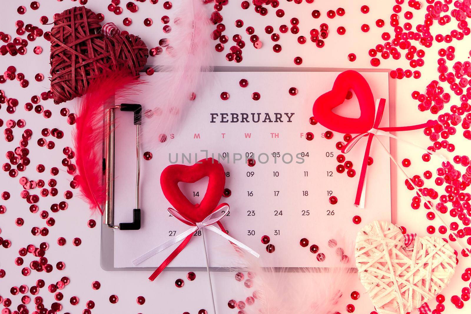 Calendar with 14th of February date. Planning Valentines day holiday. Love romantic dating. Preparing with hearts. by anna_stasiia