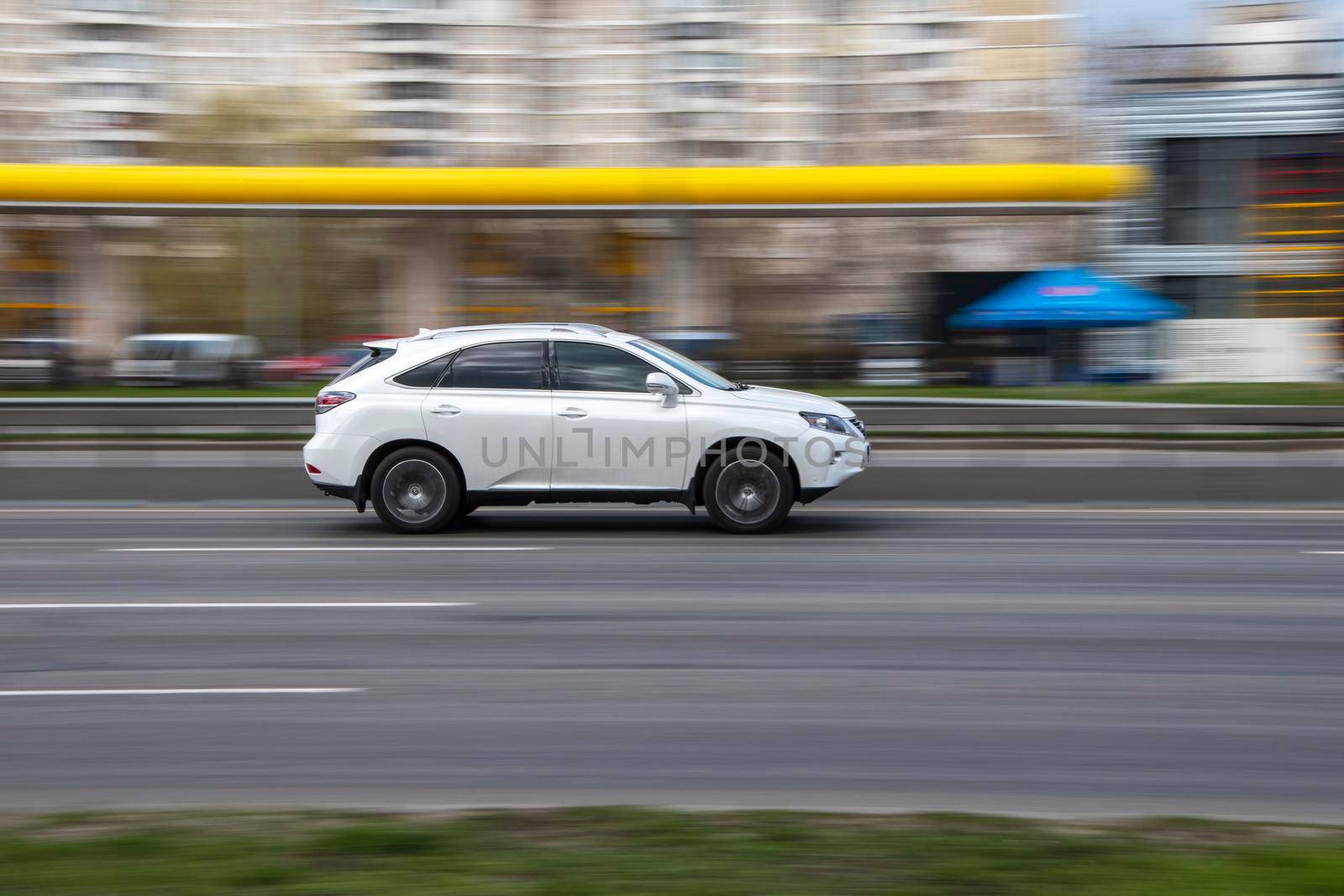 Ukraine, Kyiv - 6 April 2021: White Lexus RX car moving on the street. Editorial