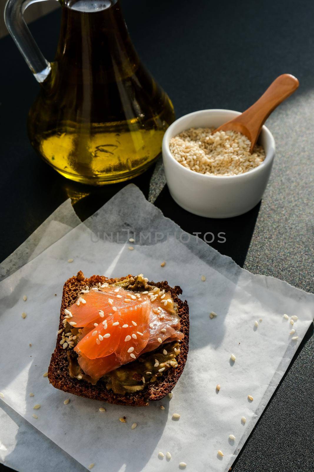 Toasted breads with avocado and salmon. Guacamole sandwiches. Healthy breakfast. Olive oil. Sesame seeds. Vegetarian healthy eating. Diet. Snack Selective focus, close up