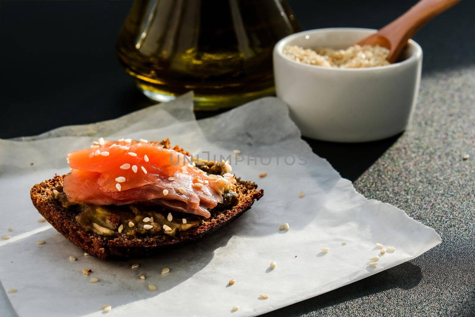 Toasted breads with avocado and salmon. Guacamole sandwiches. Healthy breakfast. Olive oil. Sesame seeds. Vegetarian healthy eating. Diet. Snack Selective focus, close up
