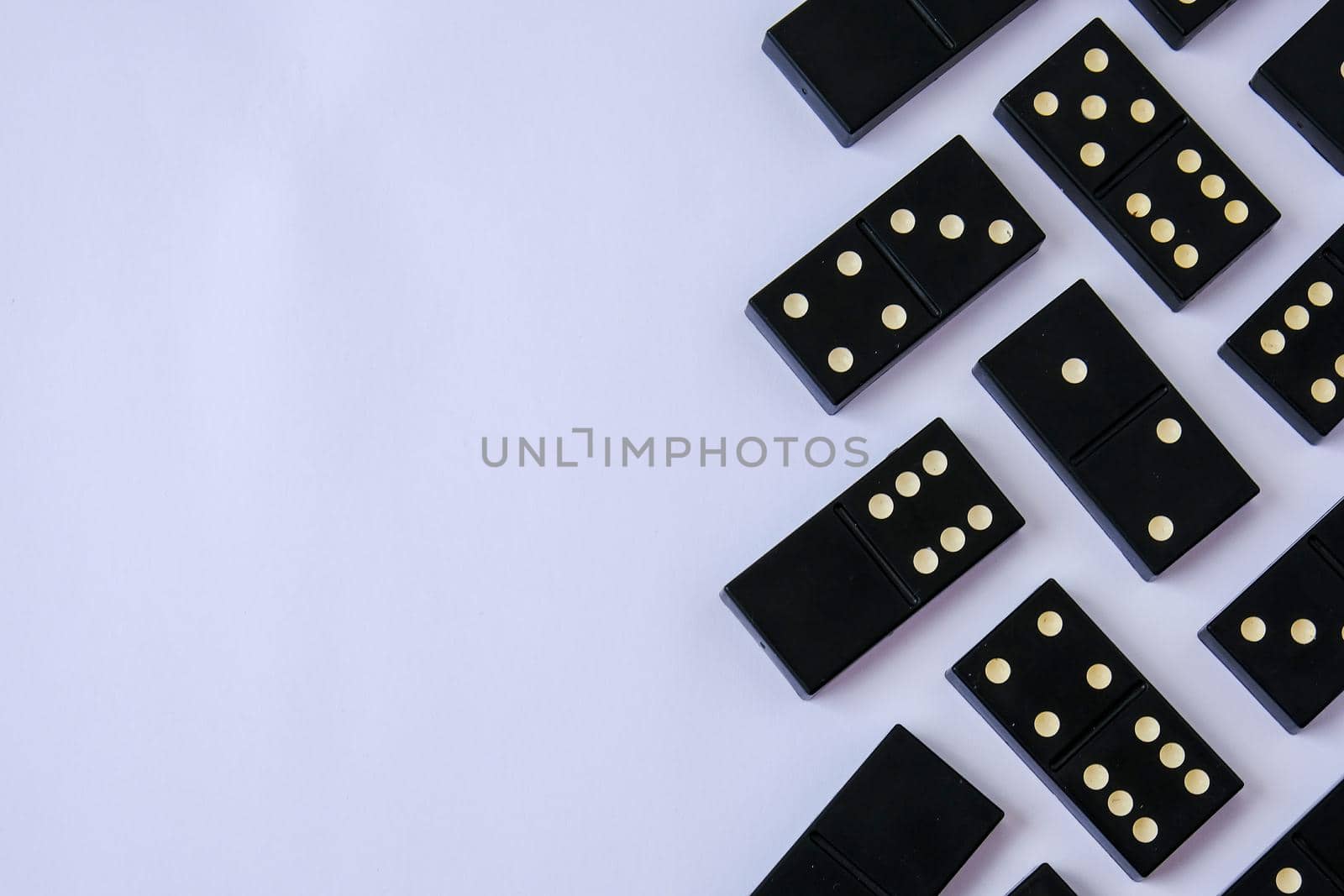 Black old, vintage dominoes on white background. The concept of the game dominoes. Selective focus. Copy space. Pastime by anna_stasiia