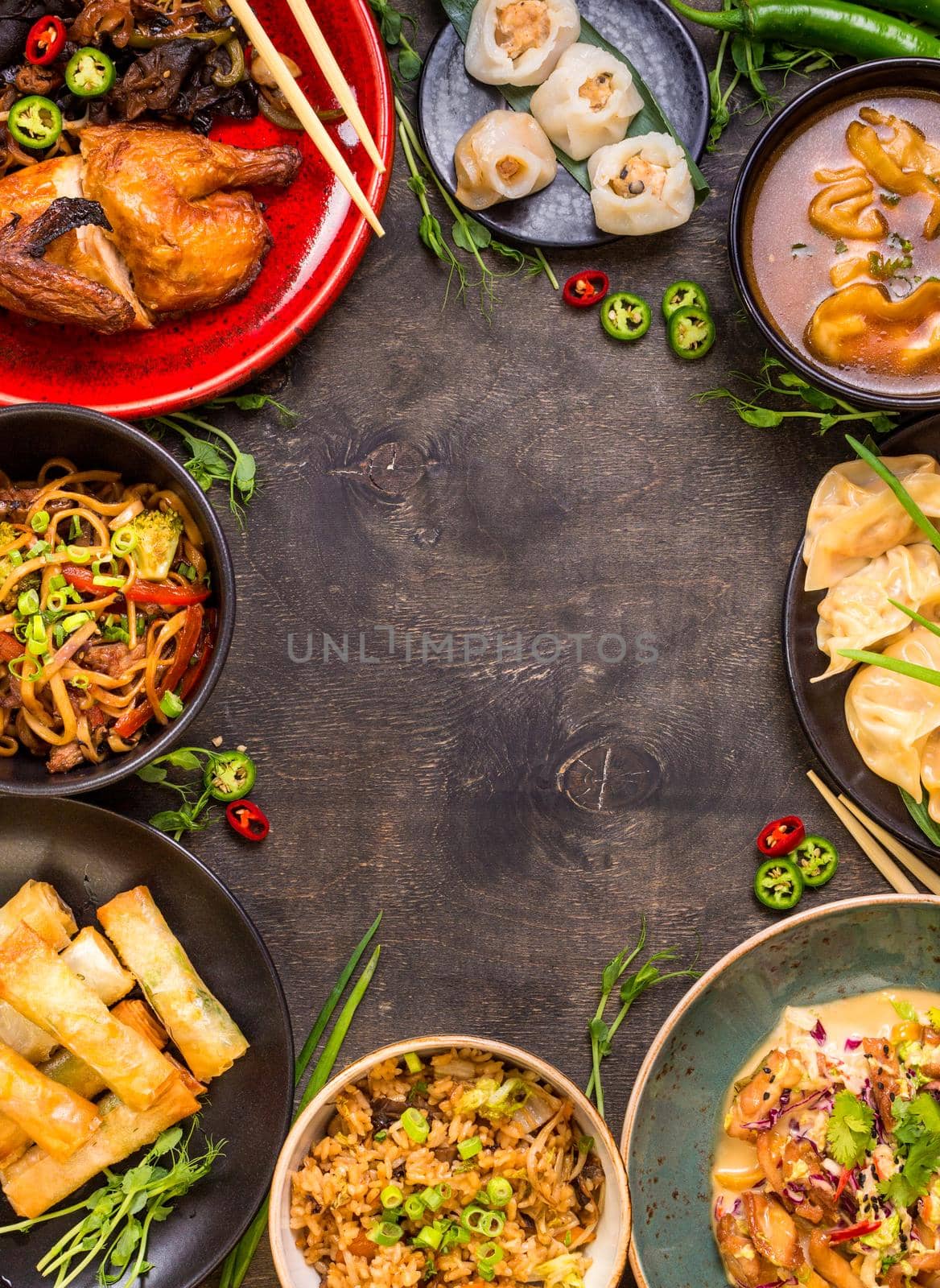 Chinese food dark background. Chinese noodles, fried rice, dumplings, peking duck, dim sum, spring rolls. Famous Chinese cuisine dishes set. Space for text. Top view. Chinese restaurant concept