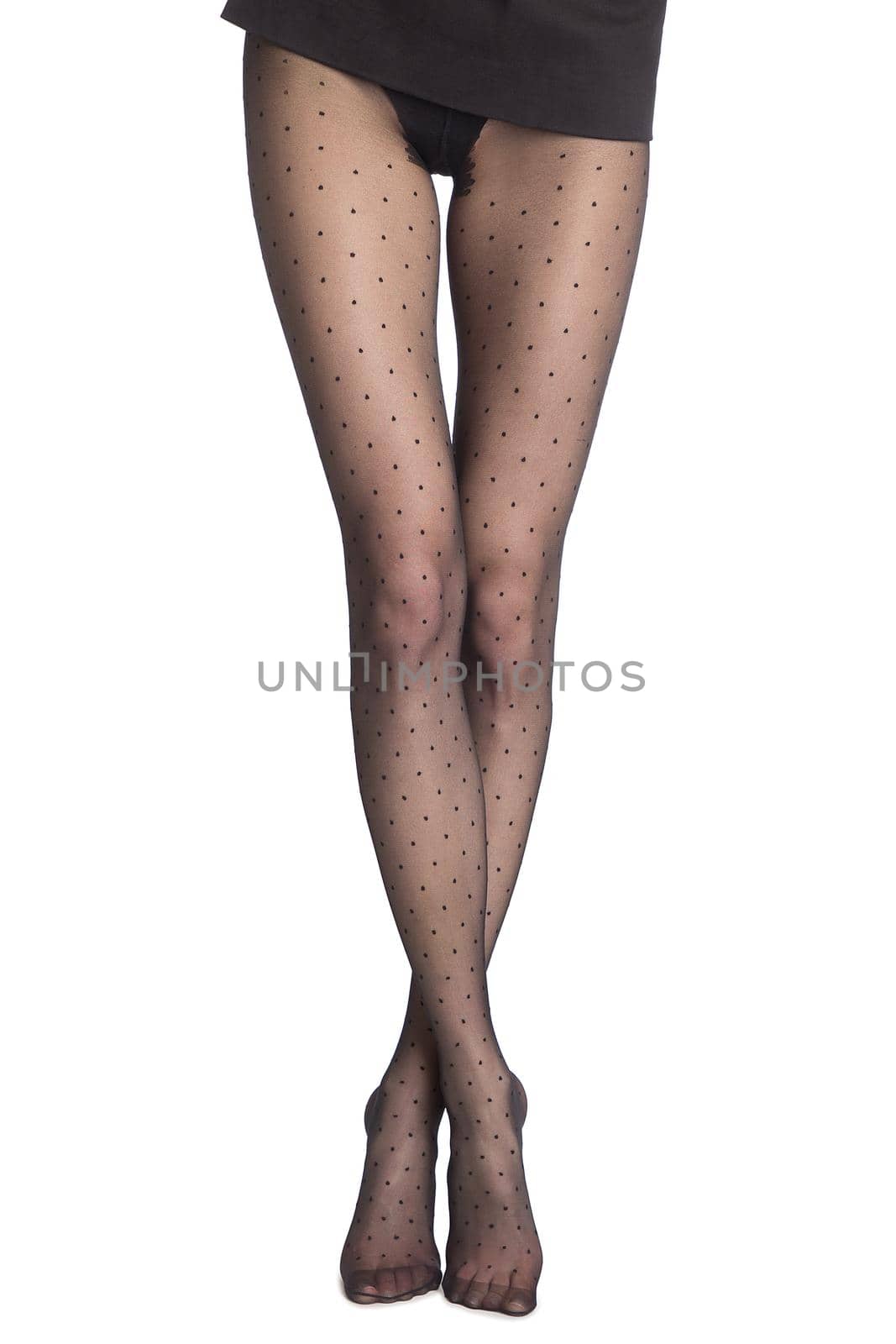 Beauty woman legs in black tights. Part body of woman. Slim attractive gorgeous female legs in black pantyhose tights standing on tiptoe isolated on white.