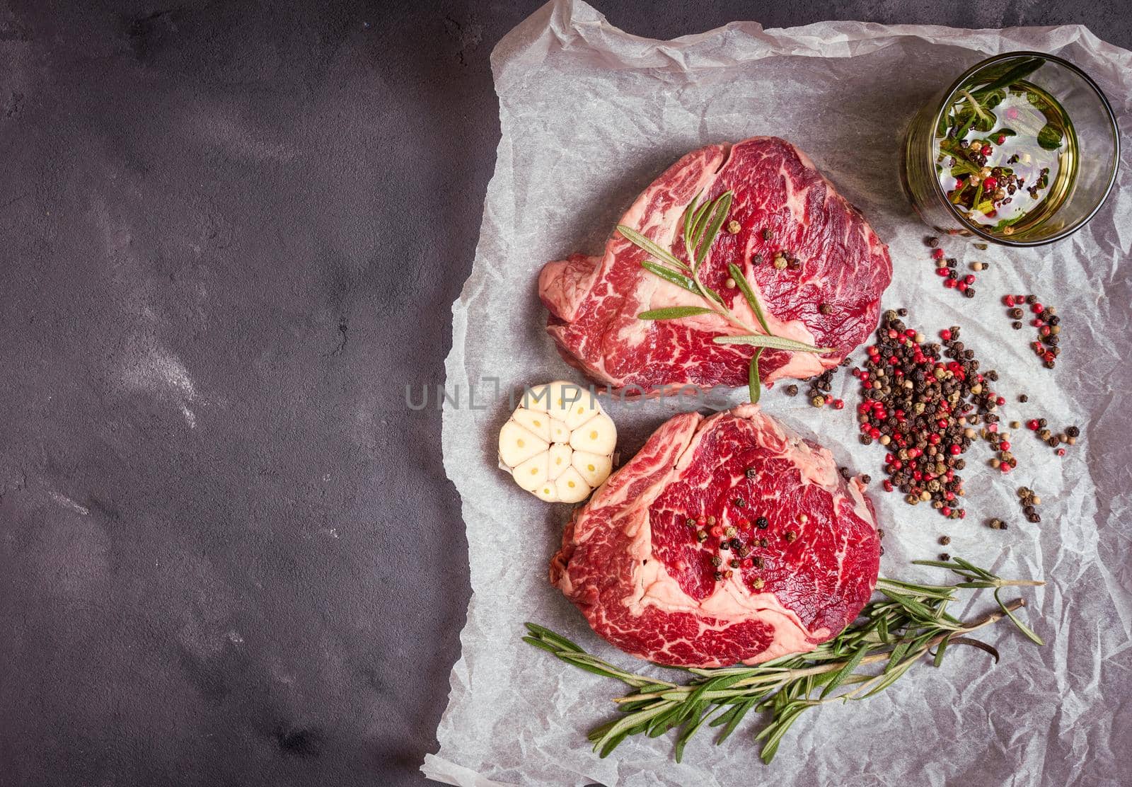 Raw meat steak on rustic concrete background ready to roasting by its_al_dente