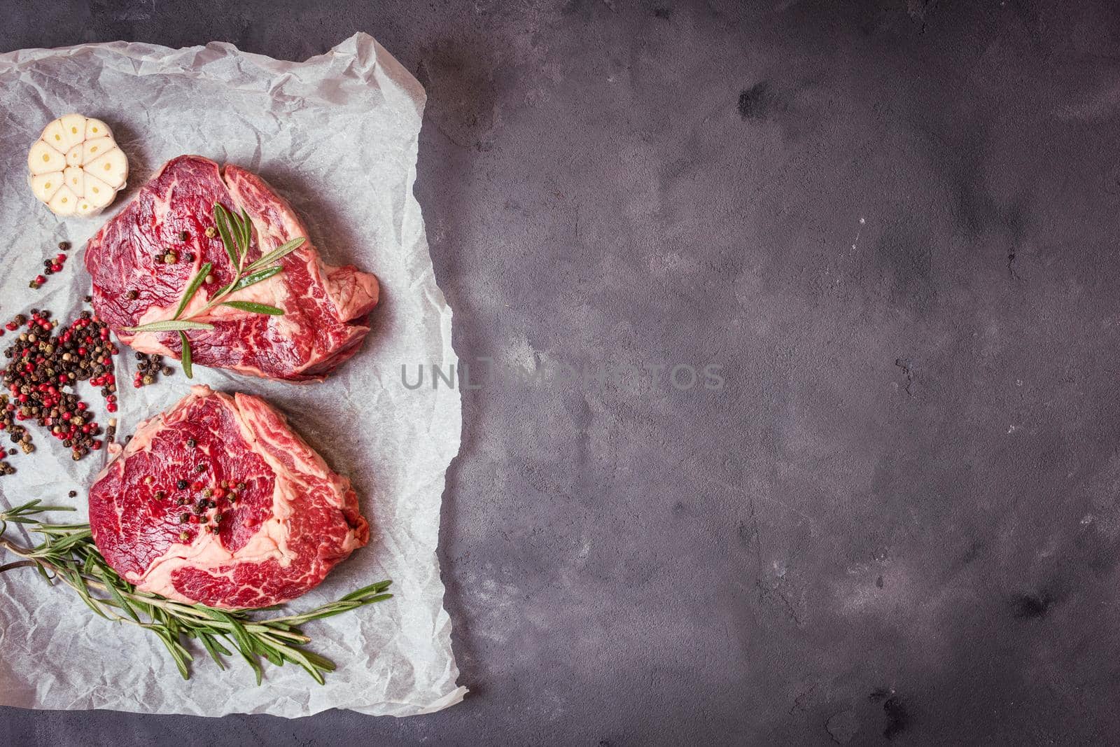 Raw meat steak on rustic concrete background ready to roasting by its_al_dente