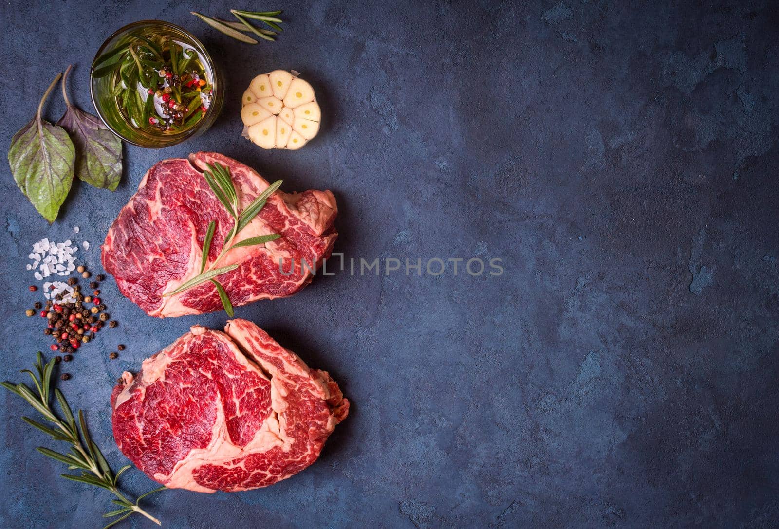 Raw meat steak on rustic concrete background ready to roasting by its_al_dente