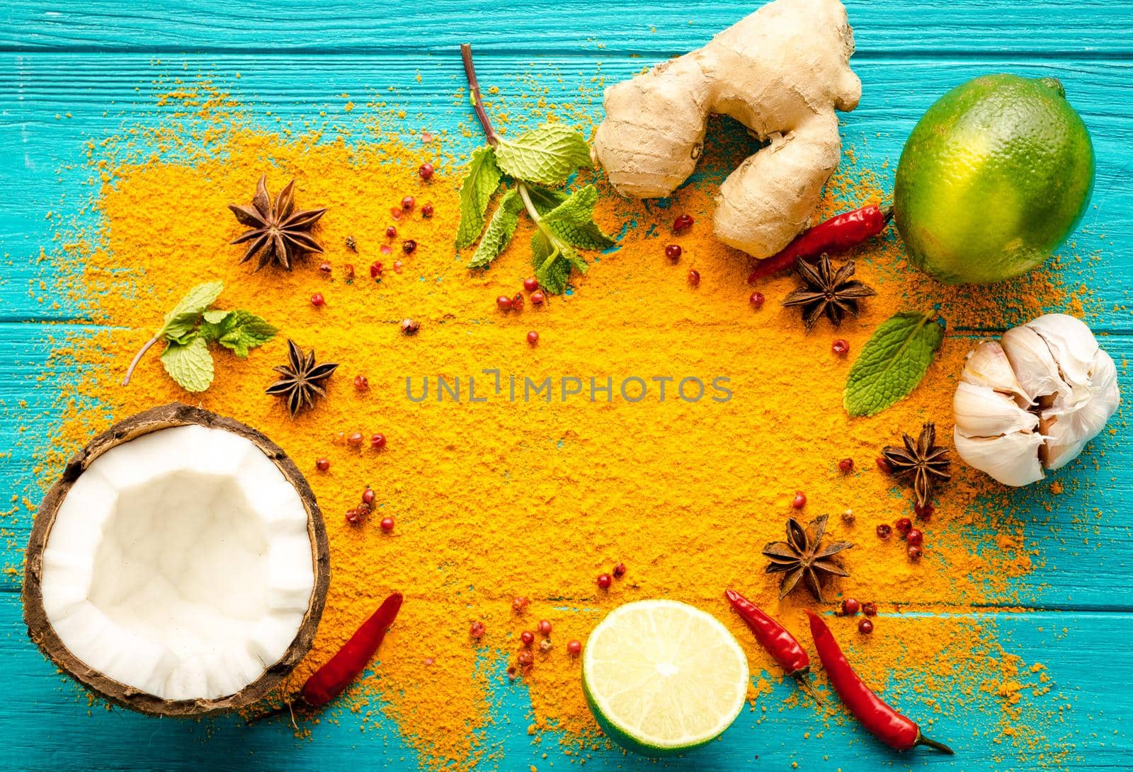 Thai food background. Ingredients for making thai food. Coconut, ginger, hot pepper, lime, curry, herbs, spices. Thai cuisine ingredients on blue wooden background. Space for text. Top view. Close-up