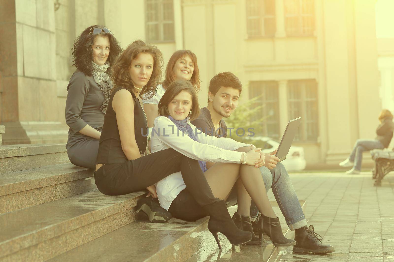 portrait of a group of students sitting in front of the University .education concept