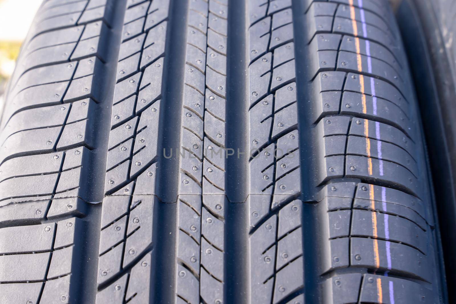 new car summer tires in a row. Car tire tread close-up. by audiznam2609