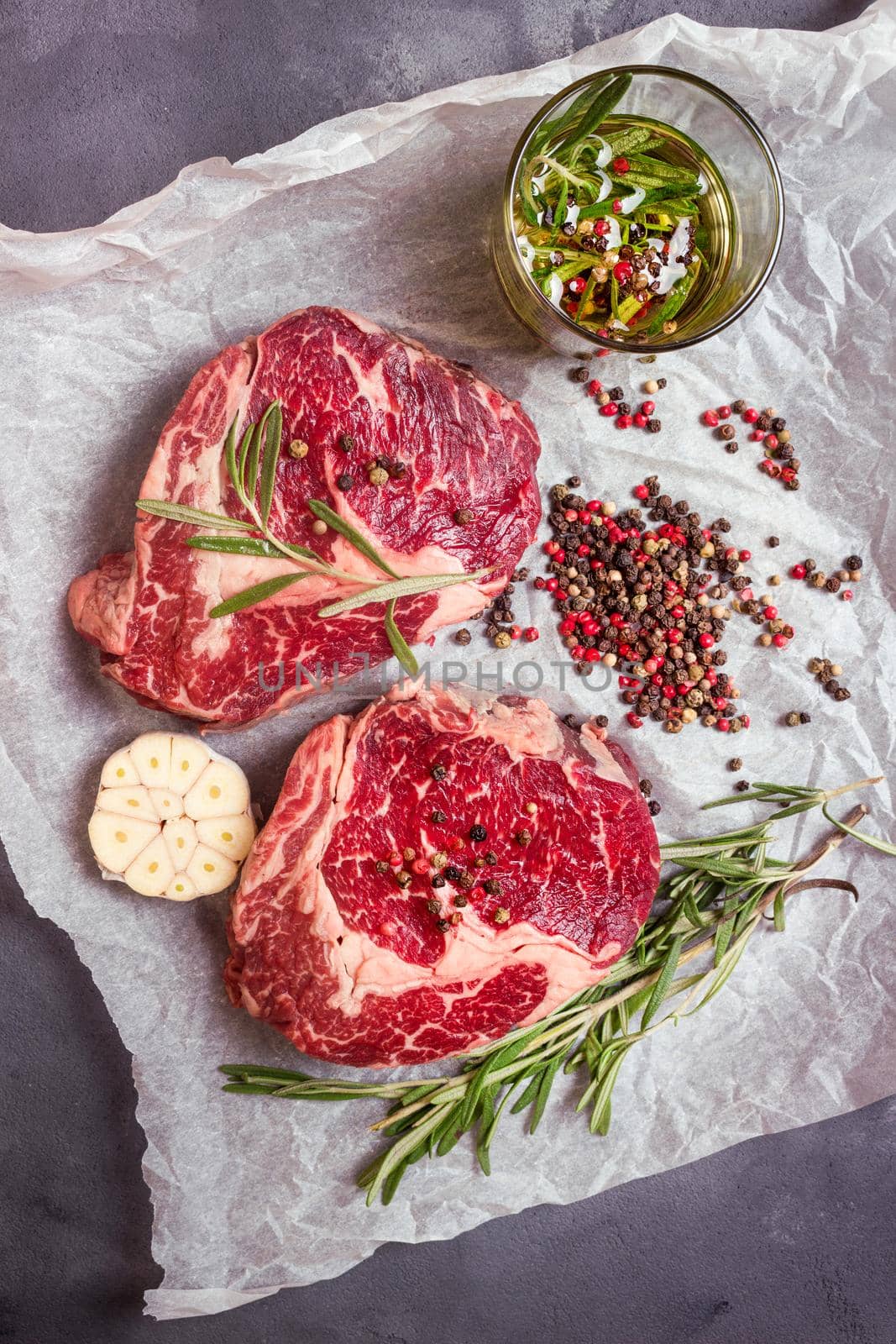 Raw meat steak on a baking paper ready to roasting by its_al_dente