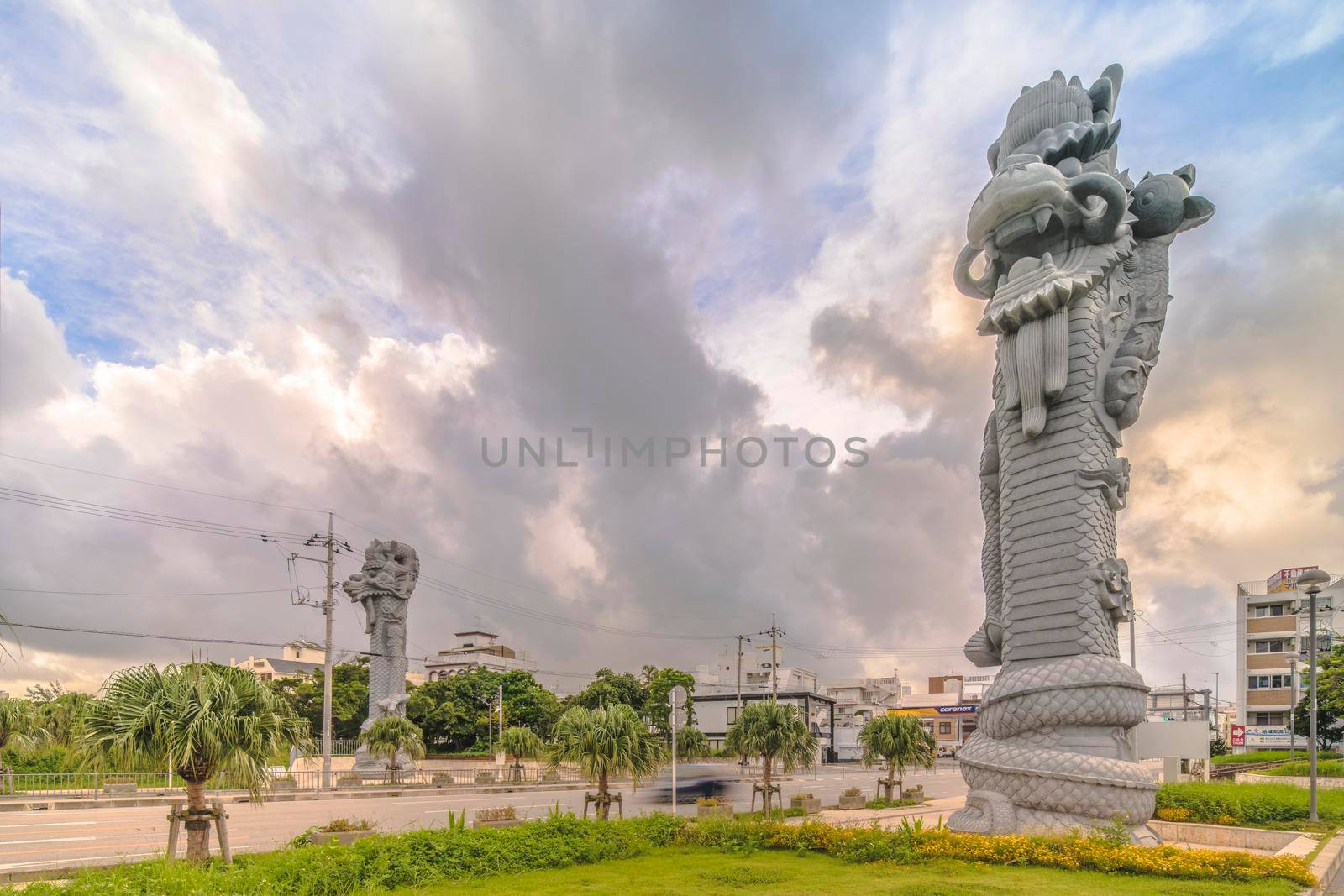 okinawa, japan - september 15 2021: Sunrise on the  giant stone dragon head of the pillars that greet cruise ship visitors close to the Naha Port Cruise Terminal dock, symbol of sister cities Naha and Fuzhou in China.