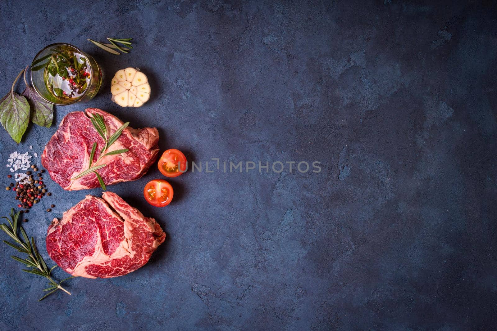 Raw meat steak on rustic concrete background ready to roasting by its_al_dente