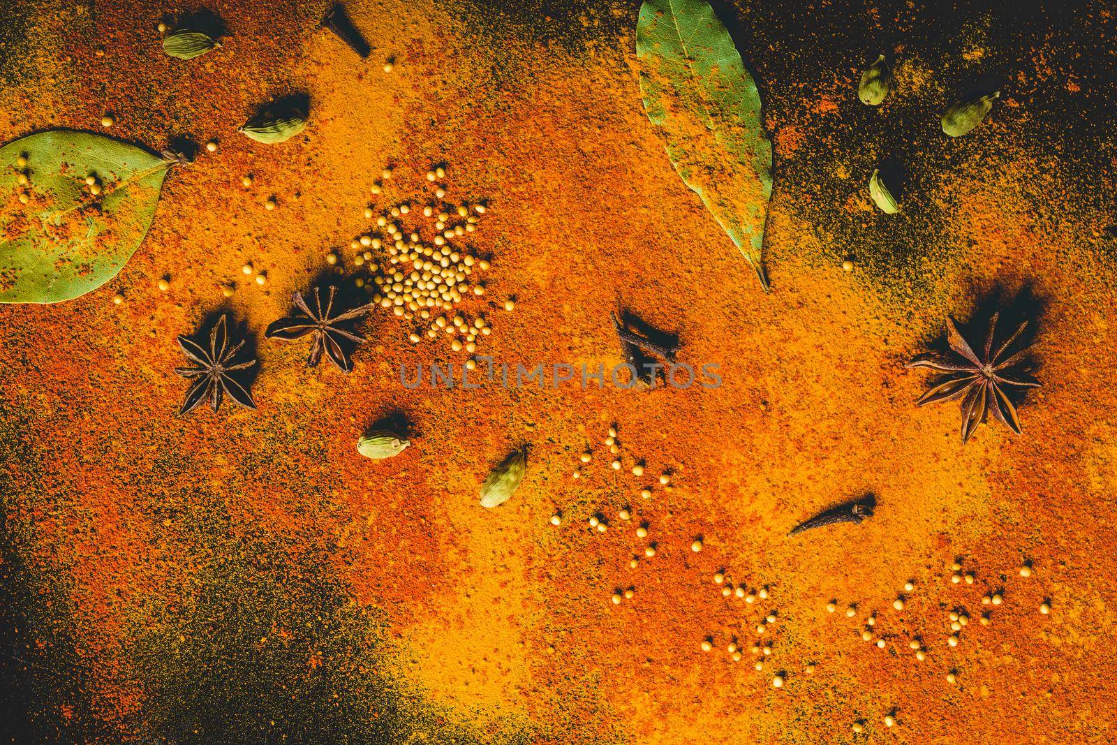 Assorted spices on dark black background. Seasonings for food. Curry, paprika, pepper, cardamom, anise, cloves, bay leaf, turmeric. Top view. Close-up. Spices concept. Spices ingredients for cooking