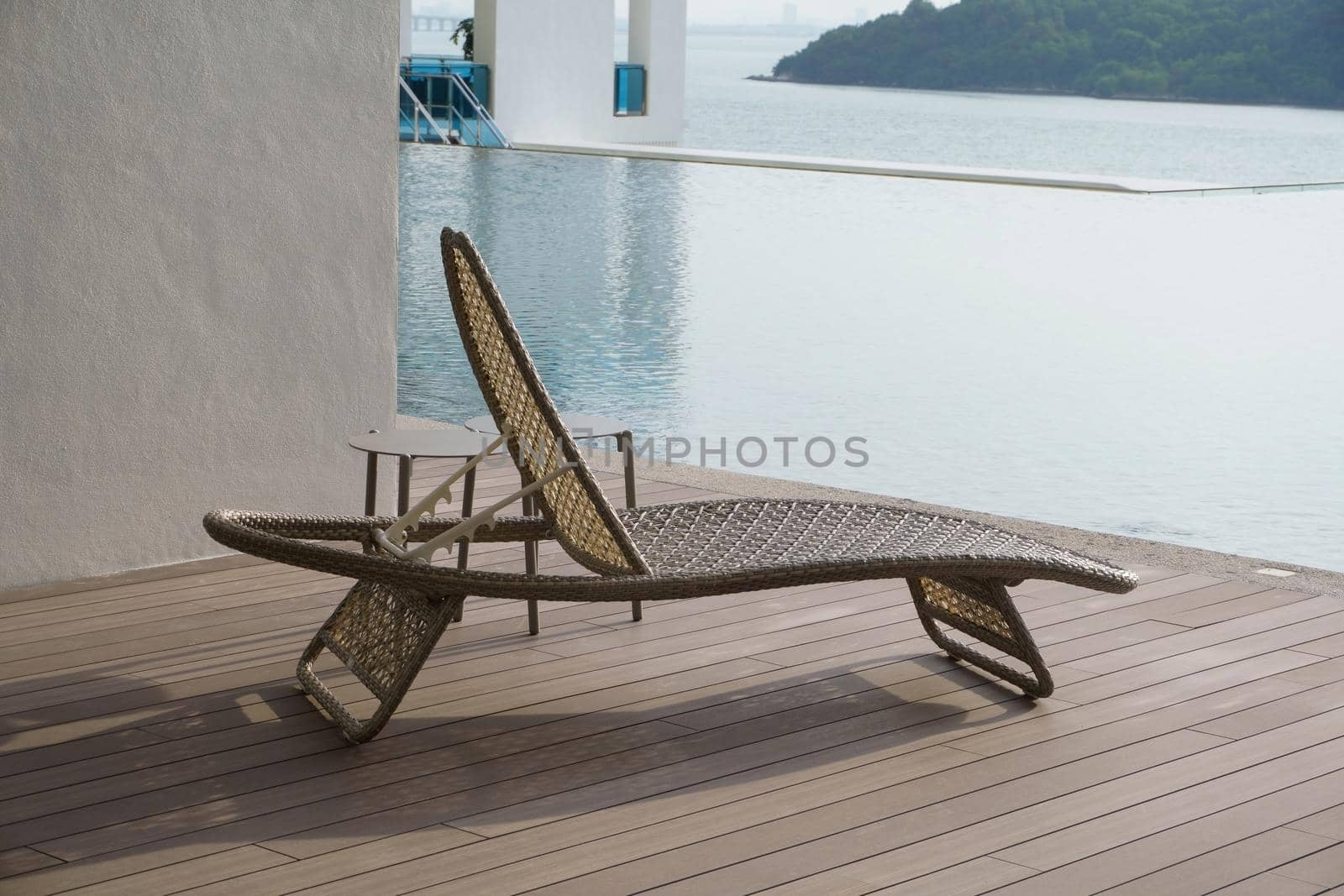 Outdoor leisure lying bed beside swimming pool by cloudyew
