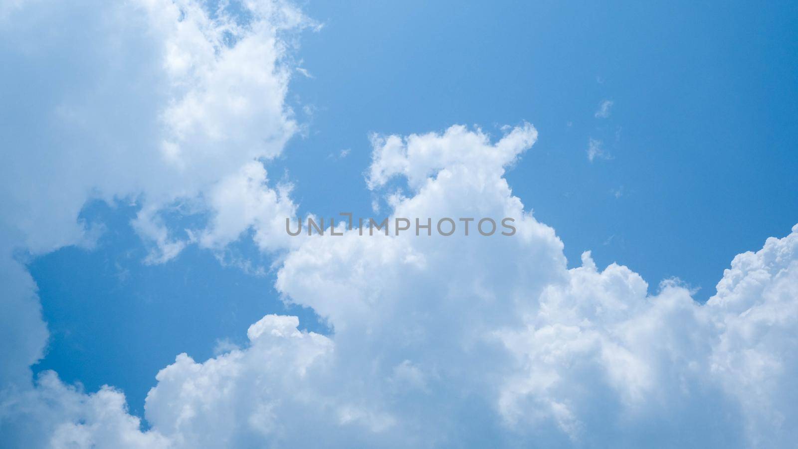 The blue sky in summer day. Blue sky white clouds. White clouds background. Nature weather of clear sky. by TEERASAK