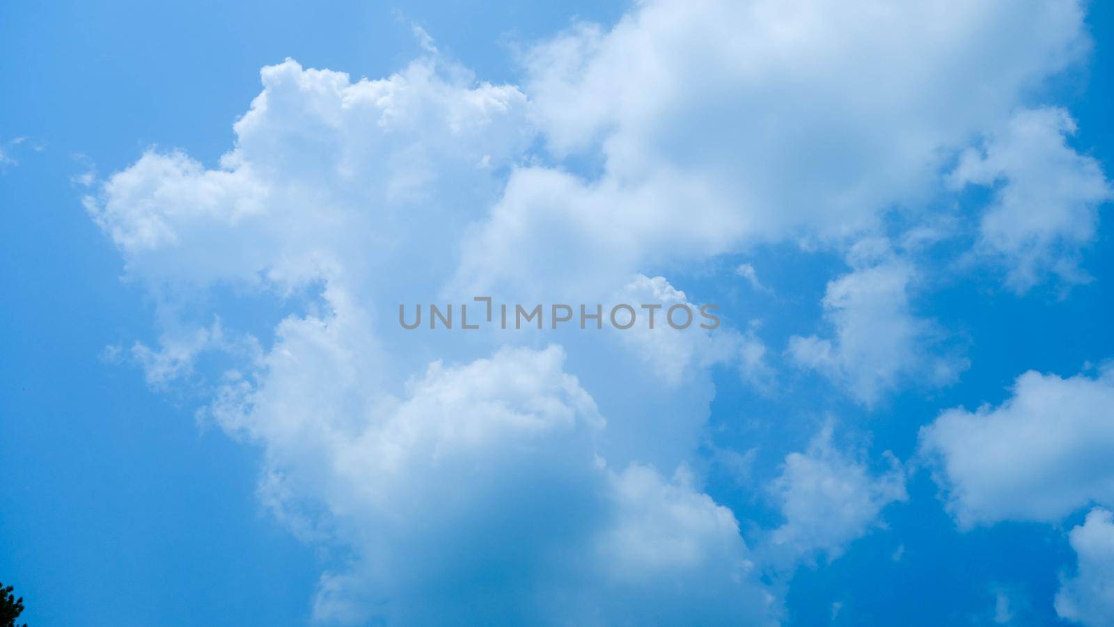 The blue sky in summer day. Blue sky white clouds. White clouds background. Nature weather of clear sky. by TEERASAK