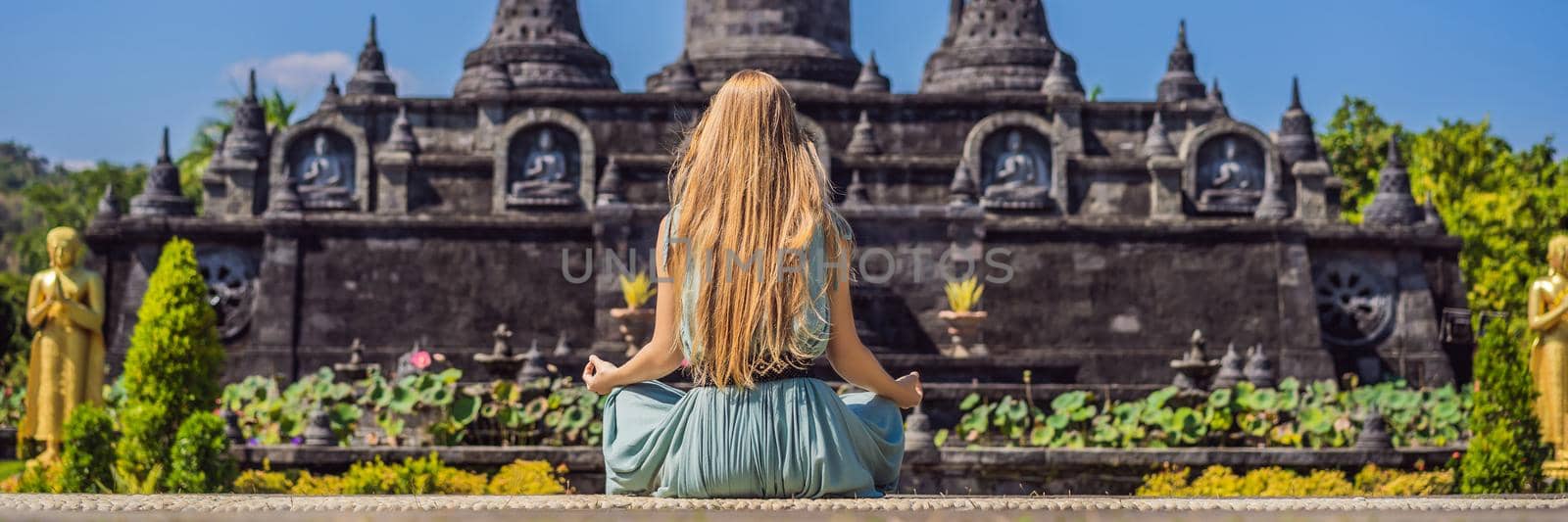 Young woman tourist in budhist temple Brahma Vihara Arama Banjar Bali, Indonesia. BANNER, LONG FORMAT