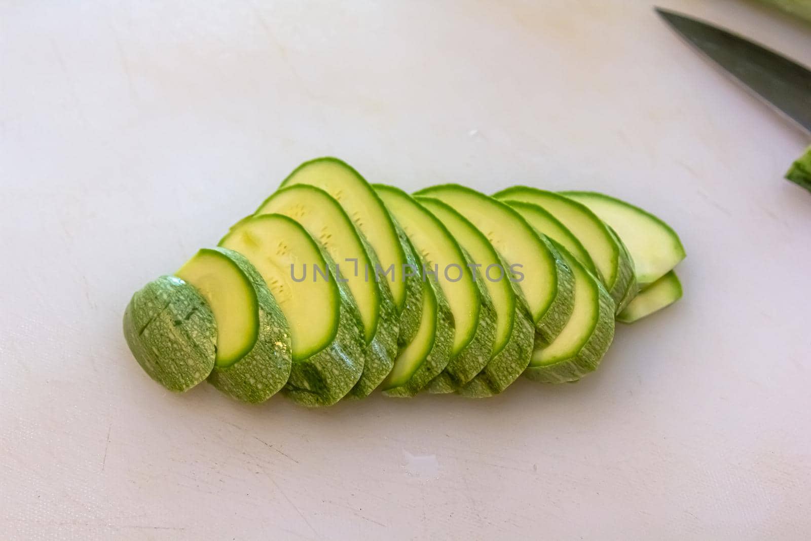 Sliced zucchini pile isolated on white, clipping path included.