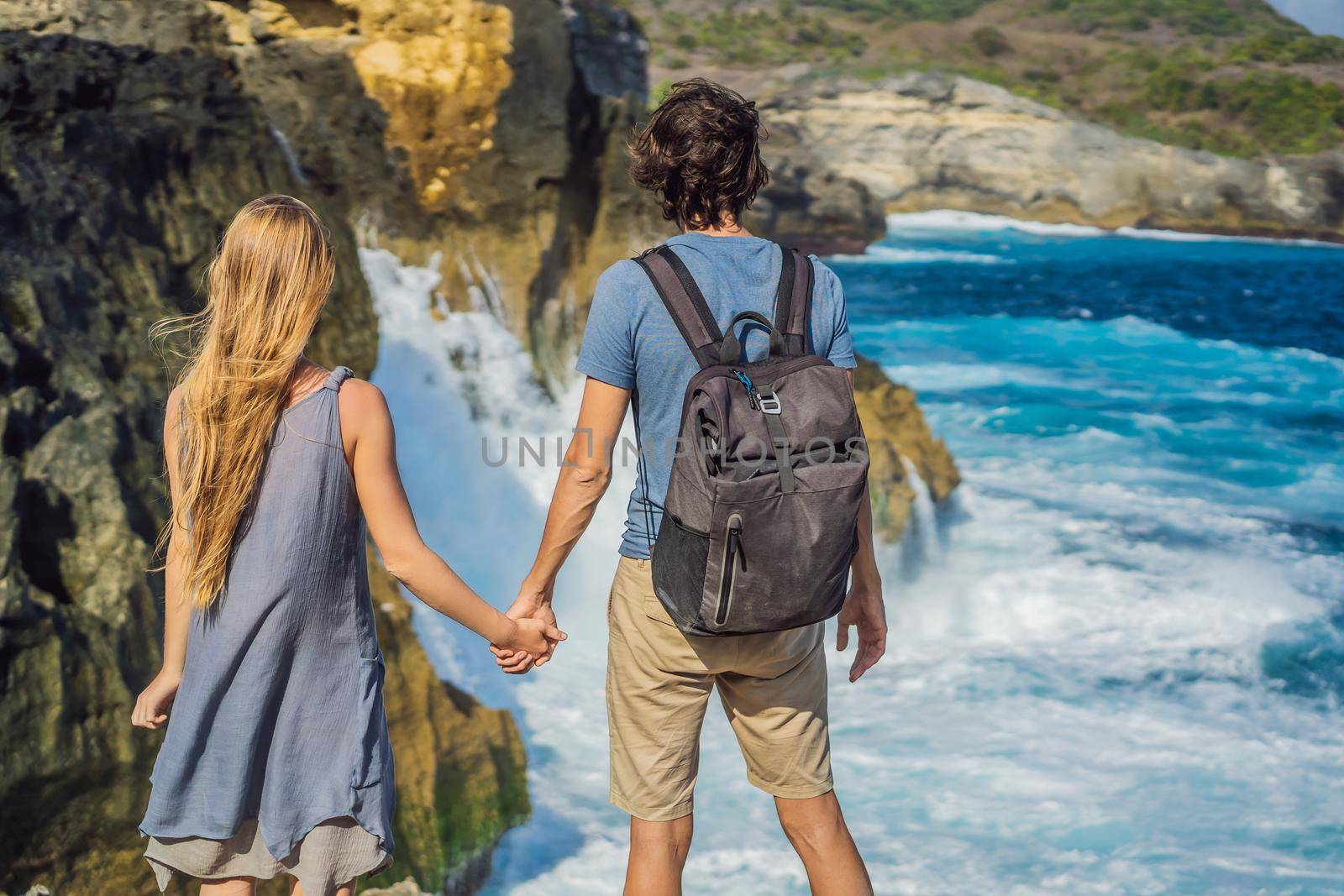 Man and woman tourists in the honeymoon against the background of the sea Angel's Billabong in Nusa Penida, Bali, Indonesia. Bali Travel Concept by galitskaya