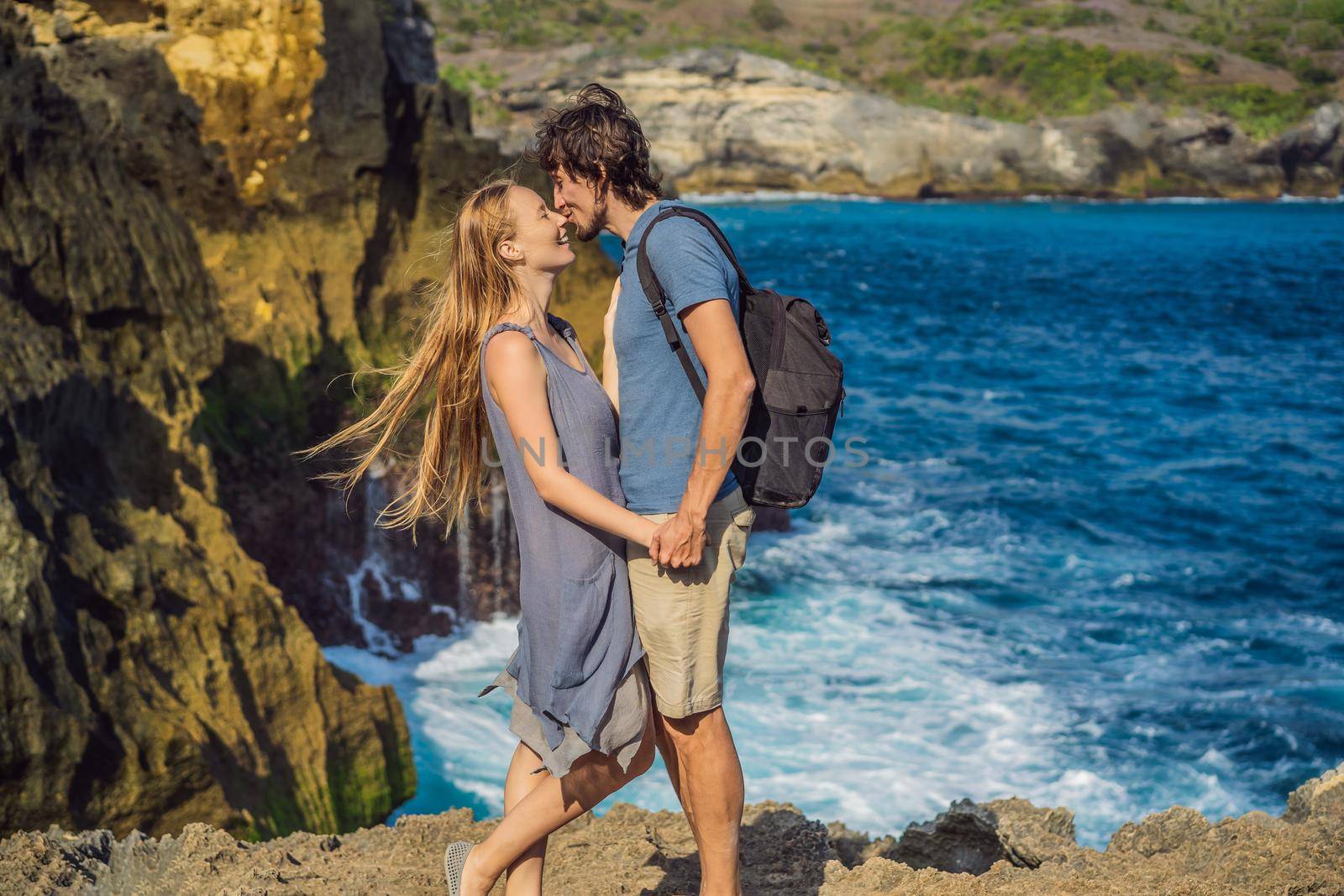 Man and woman tourists in the honeymoon against the background of the sea Angel's Billabong in Nusa Penida, Bali, Indonesia. Bali Travel Concept by galitskaya