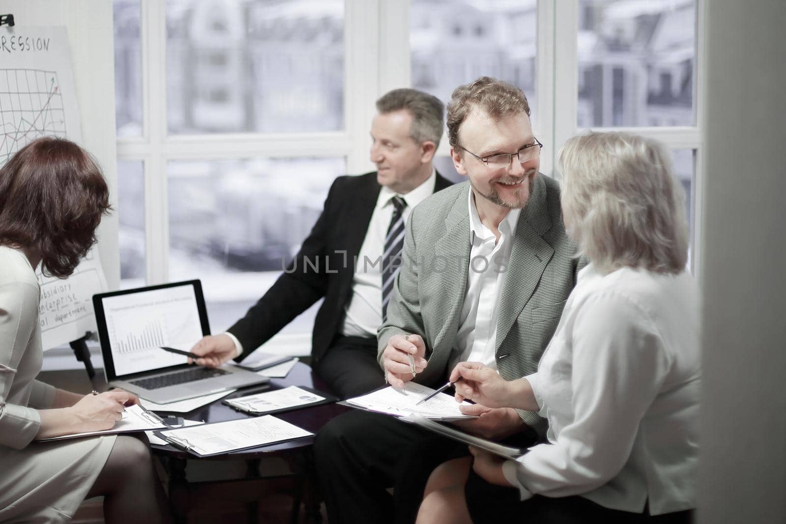 business partners discussing contract terms in office by SmartPhotoLab