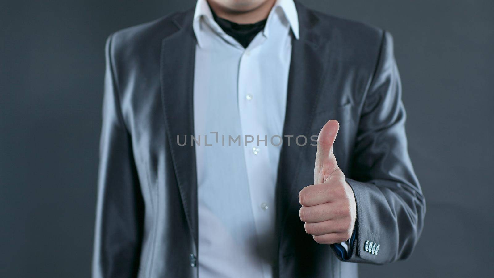 closeup.young business men showing thumb up. photo with copy space by SmartPhotoLab