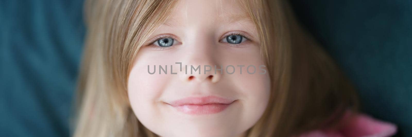 Smiling beautiful face of a little cute girl, close-up. European child, preschooler, happy childhood