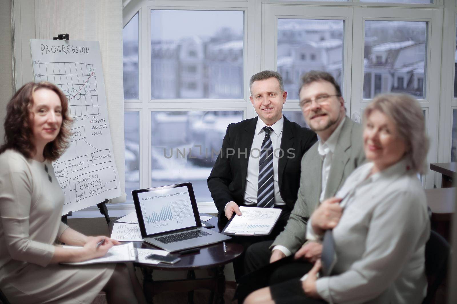 portrait of group of business people sitting near the desktop in the office