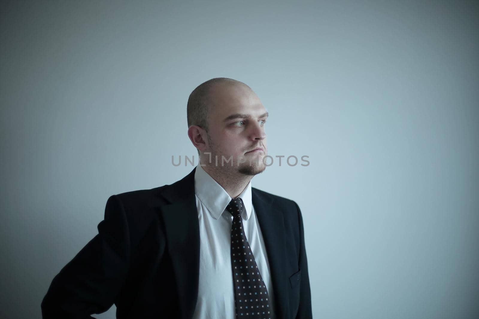 serious and confident businessman on background of blank screen by SmartPhotoLab